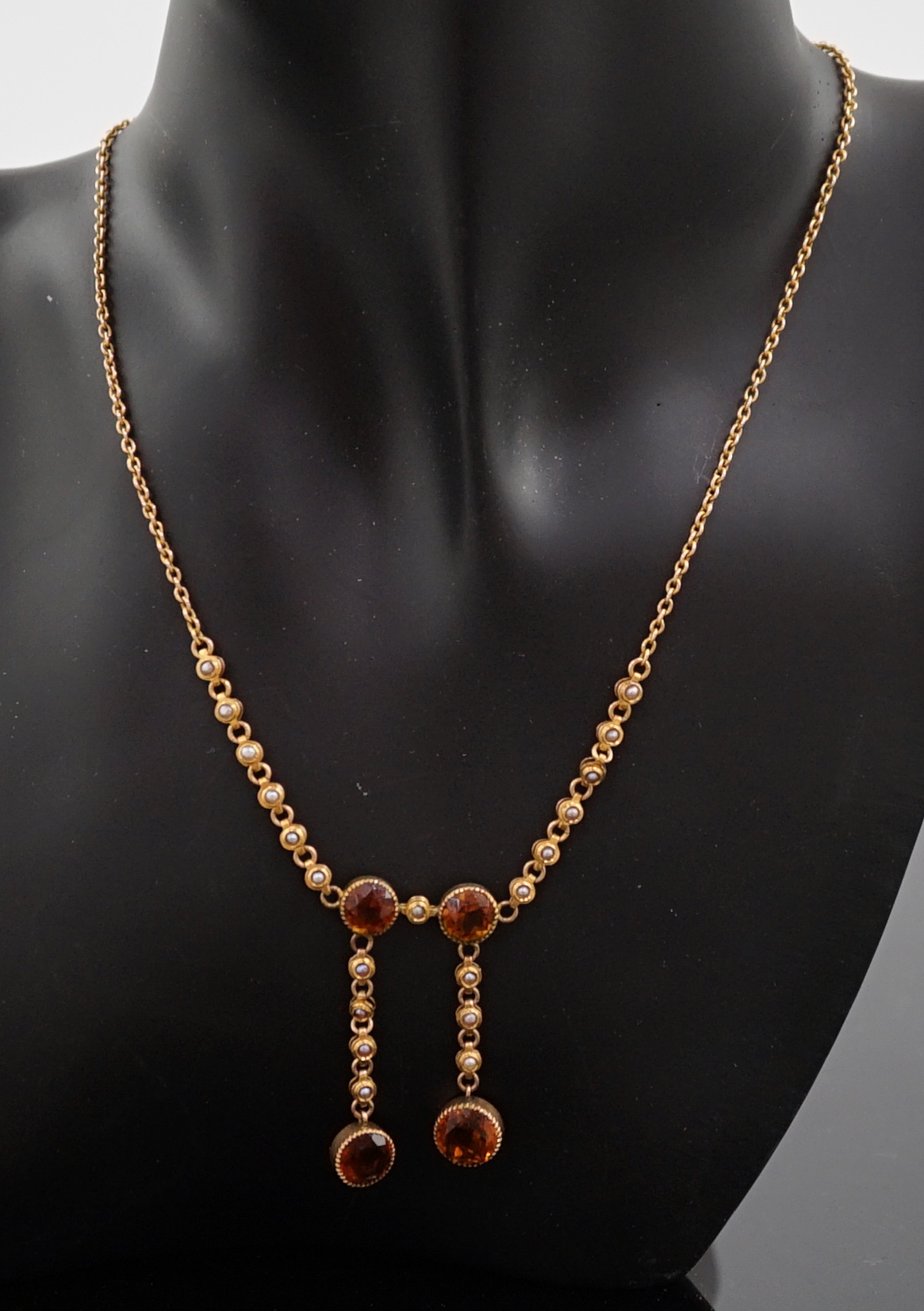 An Edwardian 15ct gold, seed pearl and citrine graduated double drop necklace